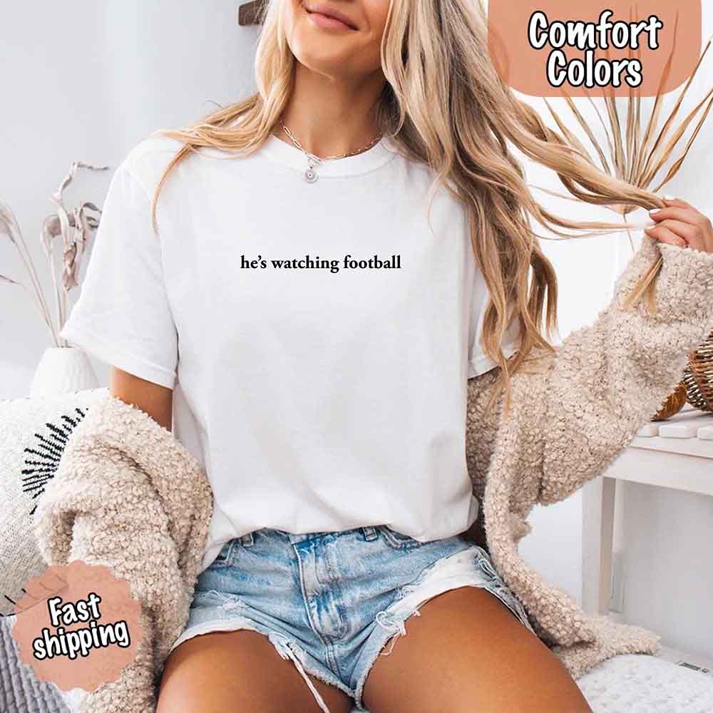 He’s Watching Football Tee - Comfort Colors Funny Shirt for Her