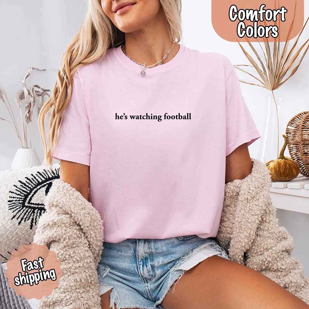 He’s Watching Football Tee - Comfort Colors Funny Shirt for Her